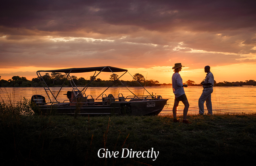 Silhouette of people raising hands against sunrise