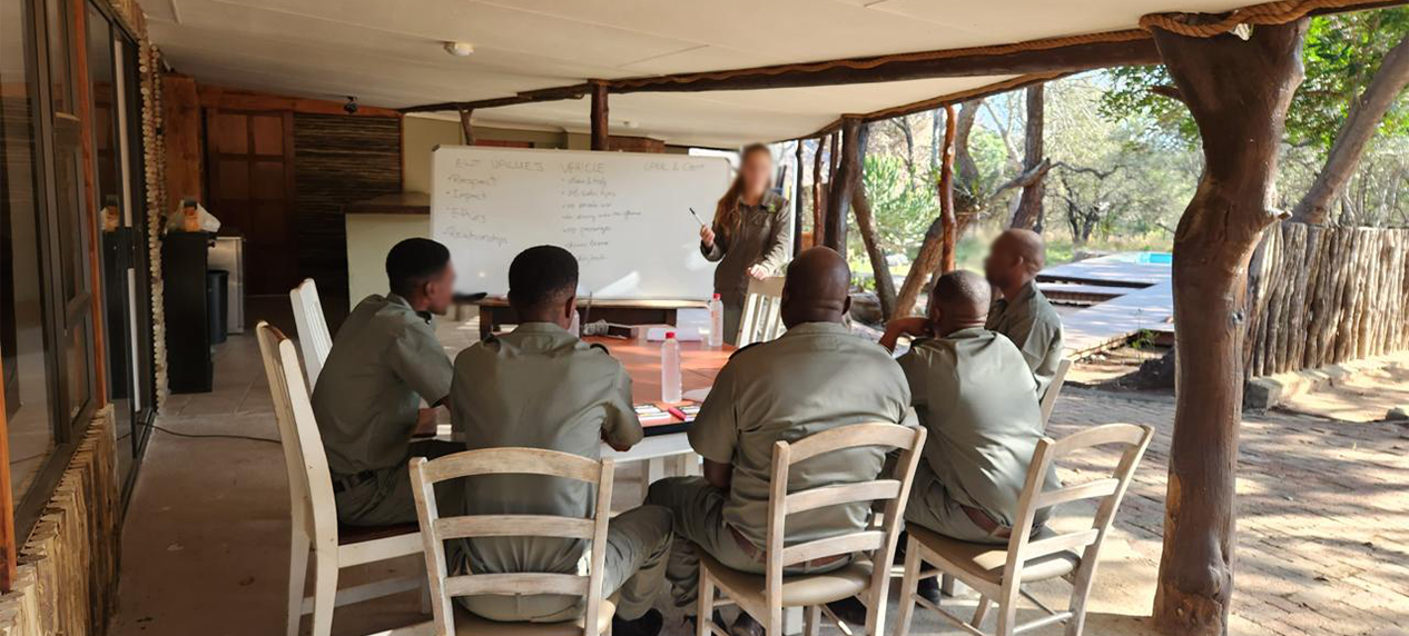 Endangered Wildlife Trust rangers working together to conserve wildlife and restore ecosystems.